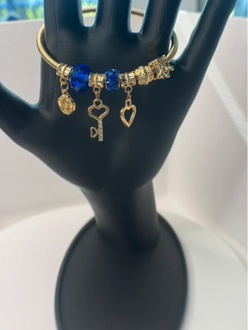 Blue and gold tone charm bracelet